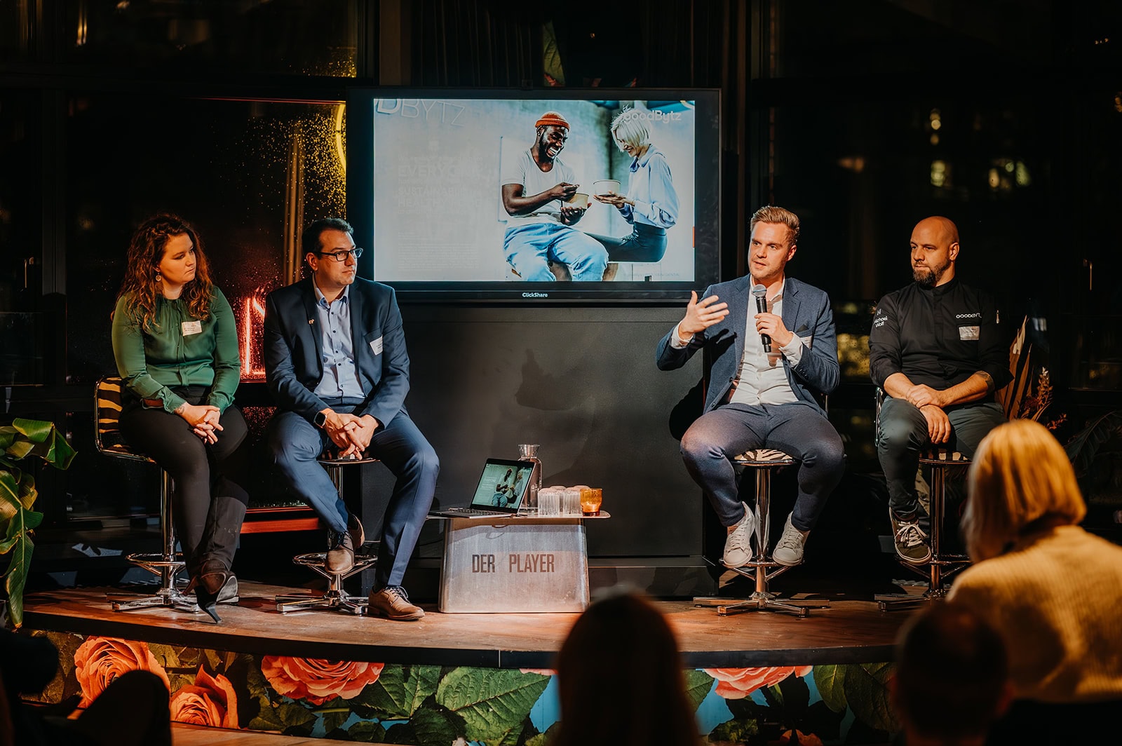 Discussiepanel met publiek in achtergrond.