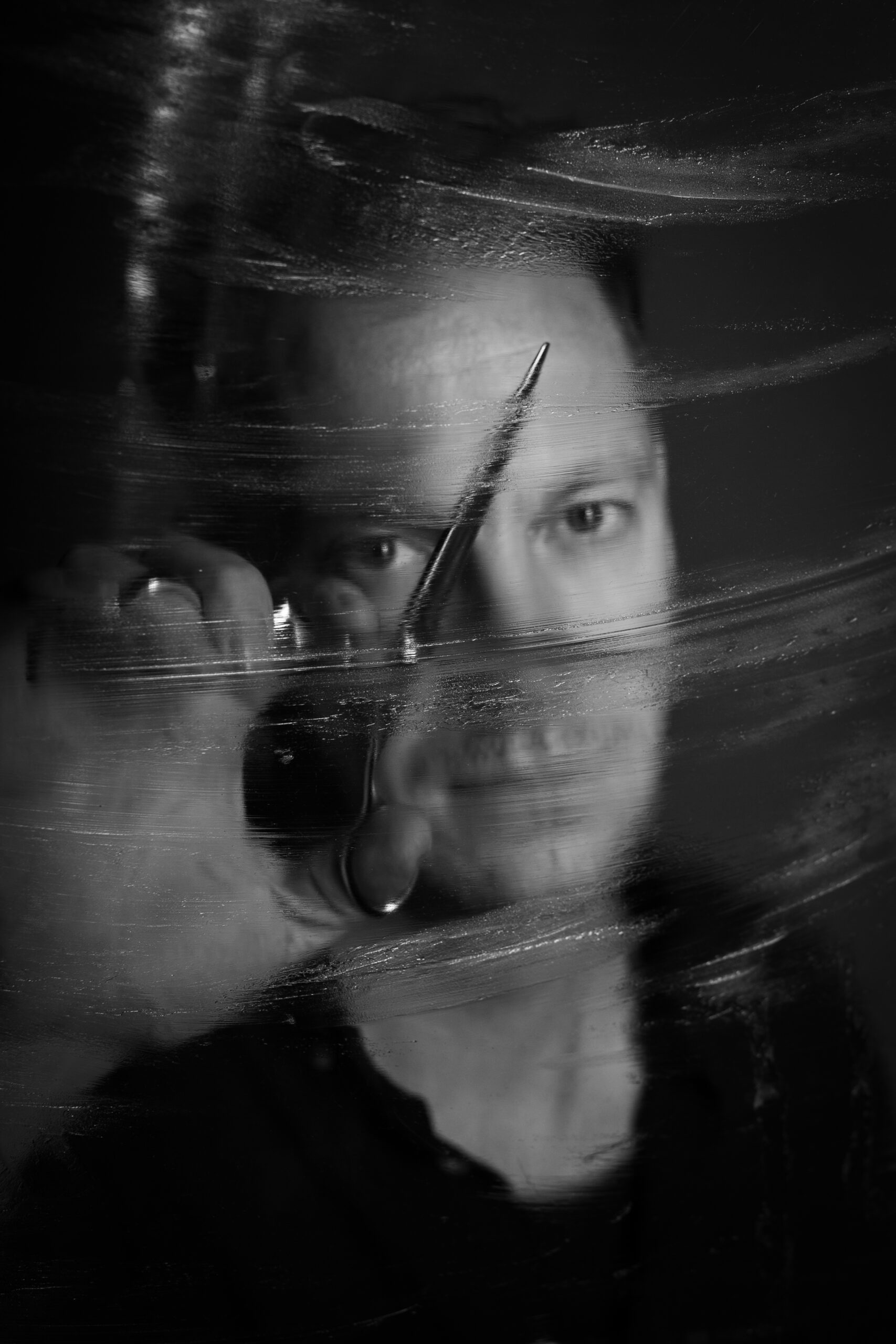 Künstlerisches Portrait von Stefan Siewert mit Pinsel, Schwarz-Weiß, kreative Fotografie.