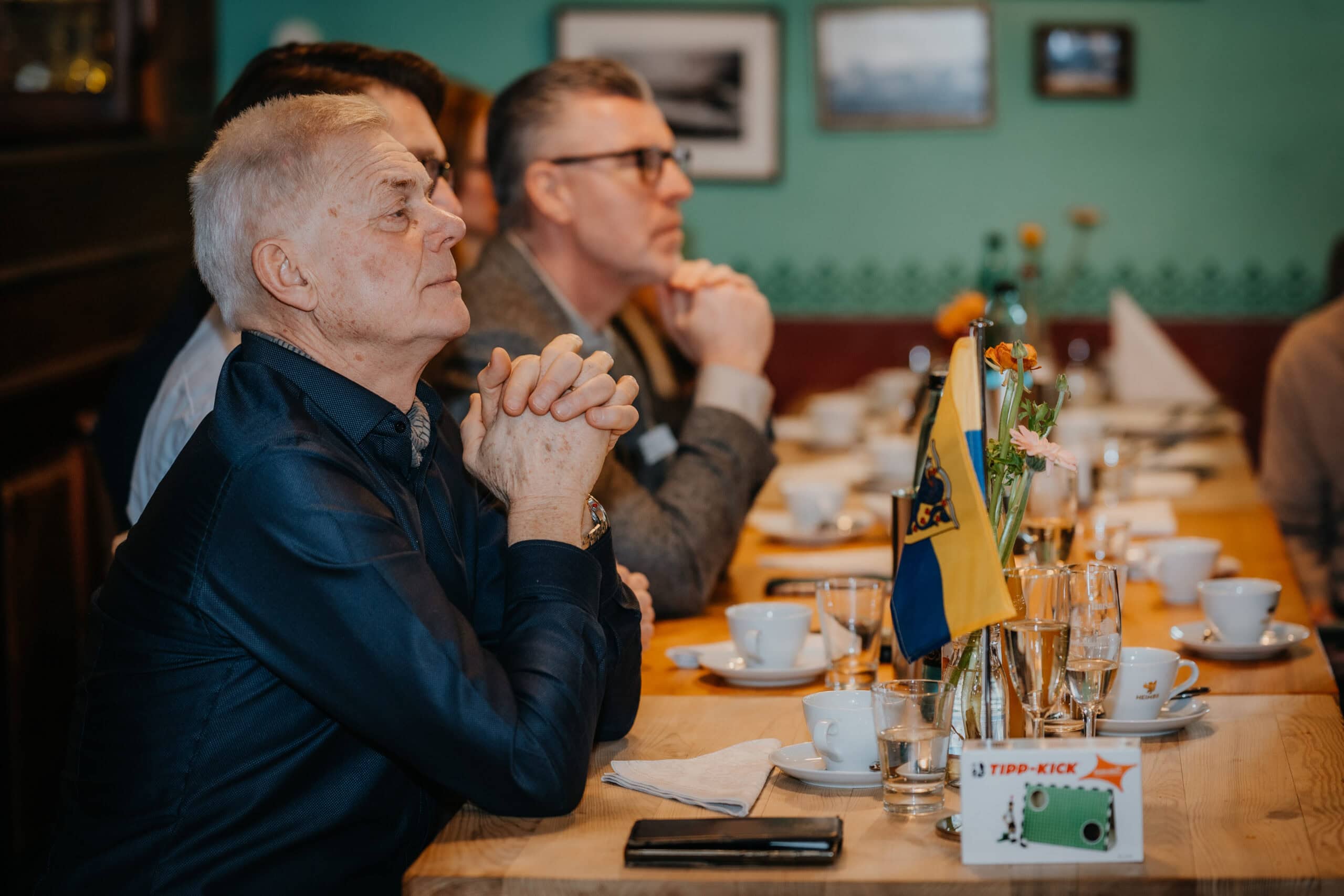 Menschen bei einem Vertelln-Meeting in einem Restaurant, konzentriert und engagiert.